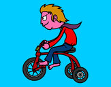 Disegno Ragazzo in triciclo pitturato su marcobois