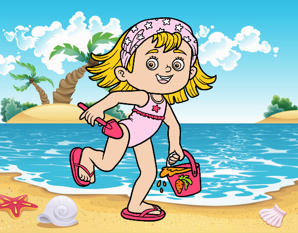 Bambina con la spiaggia secchiello e paletta