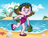 Bambina con la spiaggia secchiello e paletta